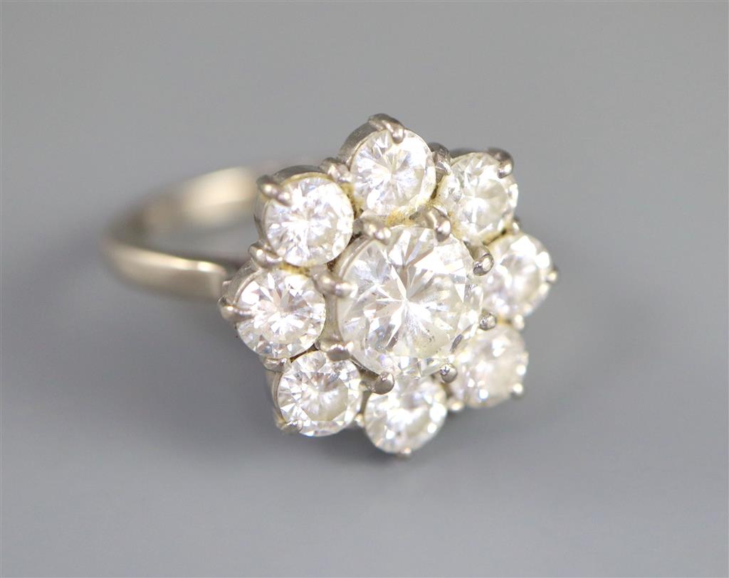 A 1970s 18ct white gold and nine stone diamond cluster ring,